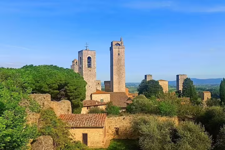 Panoramic view of San Gimignano’s medieval towers rising above Tuscan hills and vineyards on a Chianti Classic half-day tour