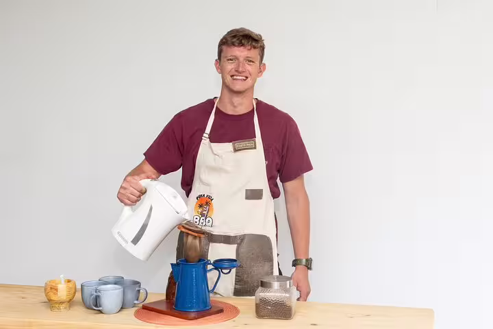 Smiling barista demonstrates coffee-making techniques on the San Jose Bites and Sights Walking Food Tour.