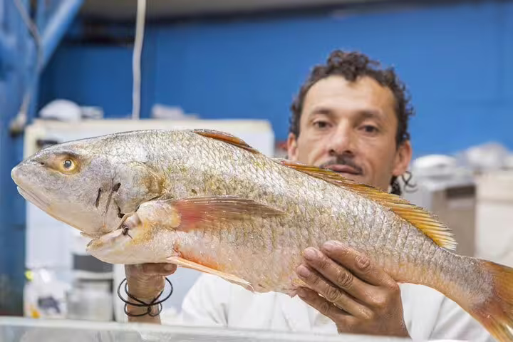 Local fishmonger in San Jose showcases fresh catch, offering an authentic taste of Costa Rica's culinary scene.