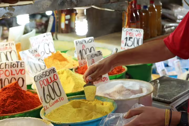 Colorful spices on display at San Jose's bustling Mercado Central, featured in the walking food tour.