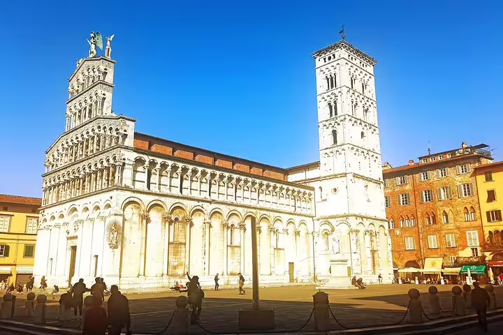 Sunlit facade of San Michele in Foro church in Lucca, visited on a Pisa & Lucca private shore excursion from La Spezia