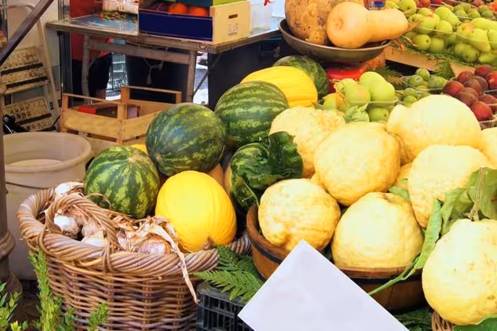 Colorful fresh fruits and vegetables including watermelons and squash at San Remo outdoor market