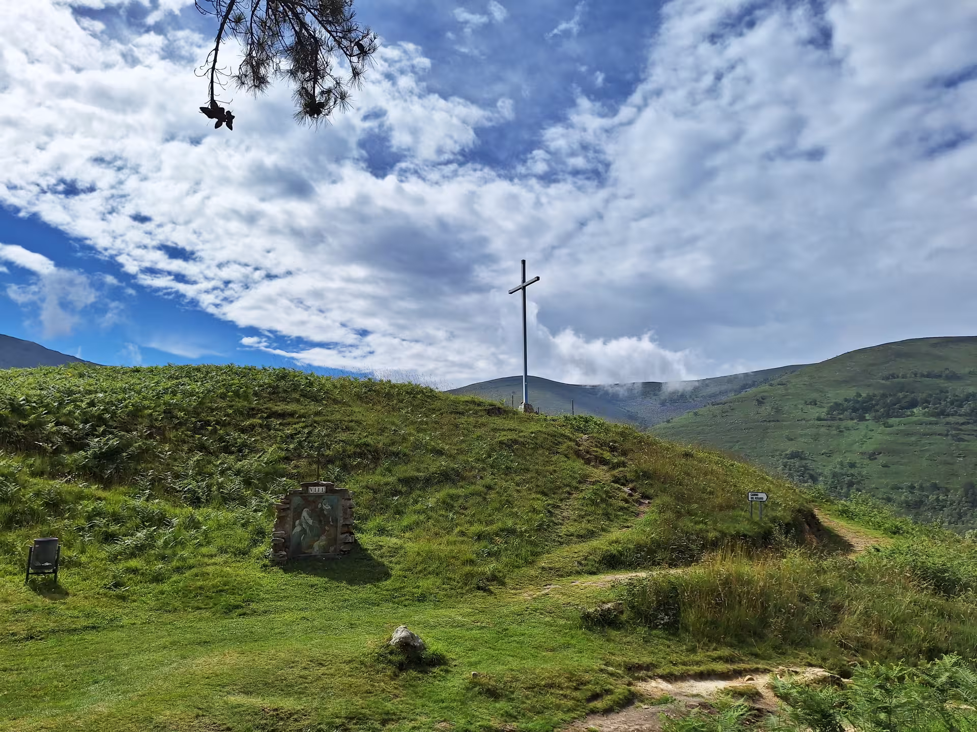 Scenic hilltop cross under a vibrant sky in San Sebastian De Garabandal, perfect for small group tours.
