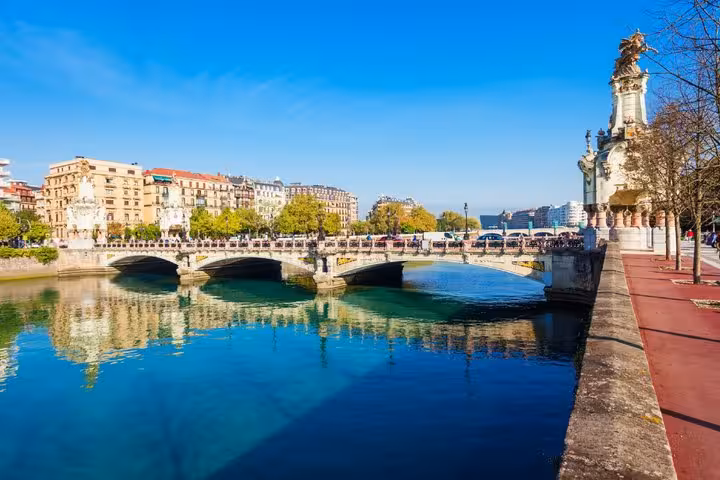 Maria Cristina Bridge over Urumea River in San Sebastian on a sunny day with historic buildings