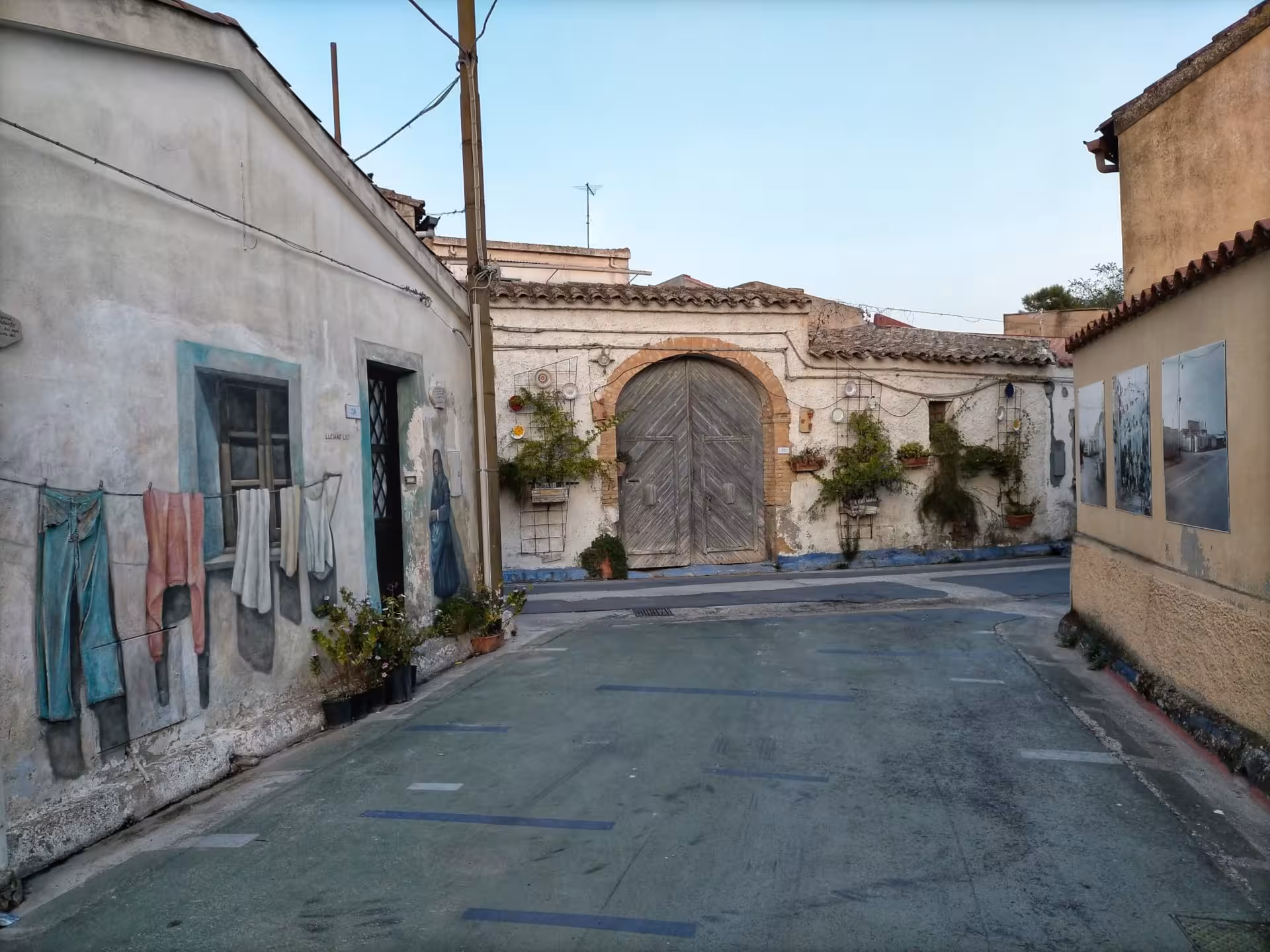 Wander through San Sperate's charming streets showcasing intricate wall art and rustic architecture.