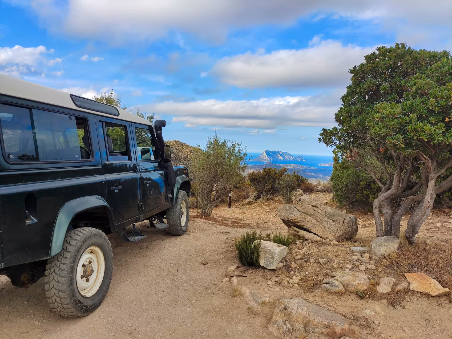 Off-road jeep with a scenic view of the coastline on the San Teodoro tour to Rio Pitrisconi.