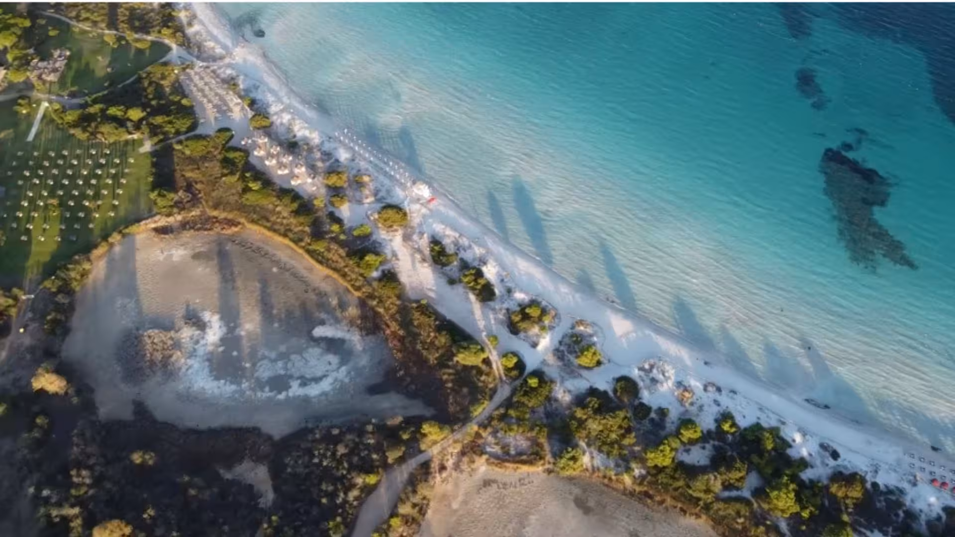 Stunning aerial view of San Teodoro's coastline with turquoise waters and white sandy beaches on a sailing tour.