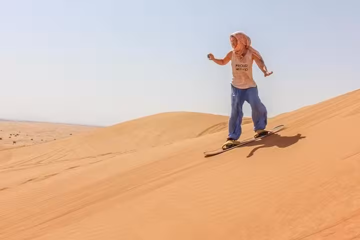 Sandboarding down Fayoum dunes near Magic Lake, adrenaline desert adventure on Cairo to Fayoum day trip
