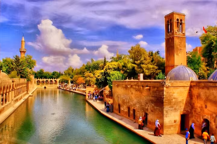 Sanliurfa Balikligol canal walkway and historic stone buildings, stop on Nemrut Gobekli Tepe tour