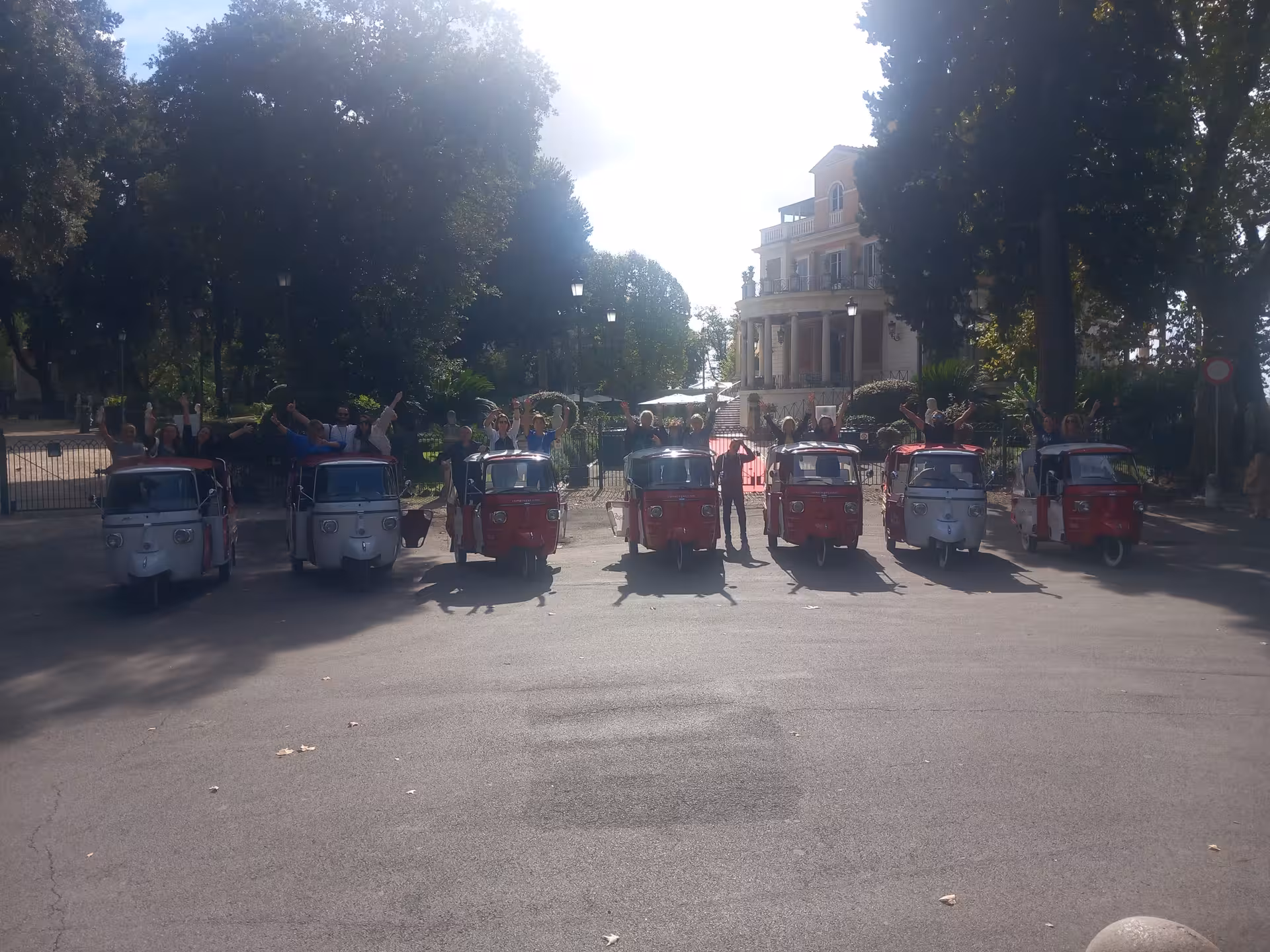 Group of people on tuk-tuks enjoying a scenic tour near Sant'Angelo Castle, a must-see in Rome.