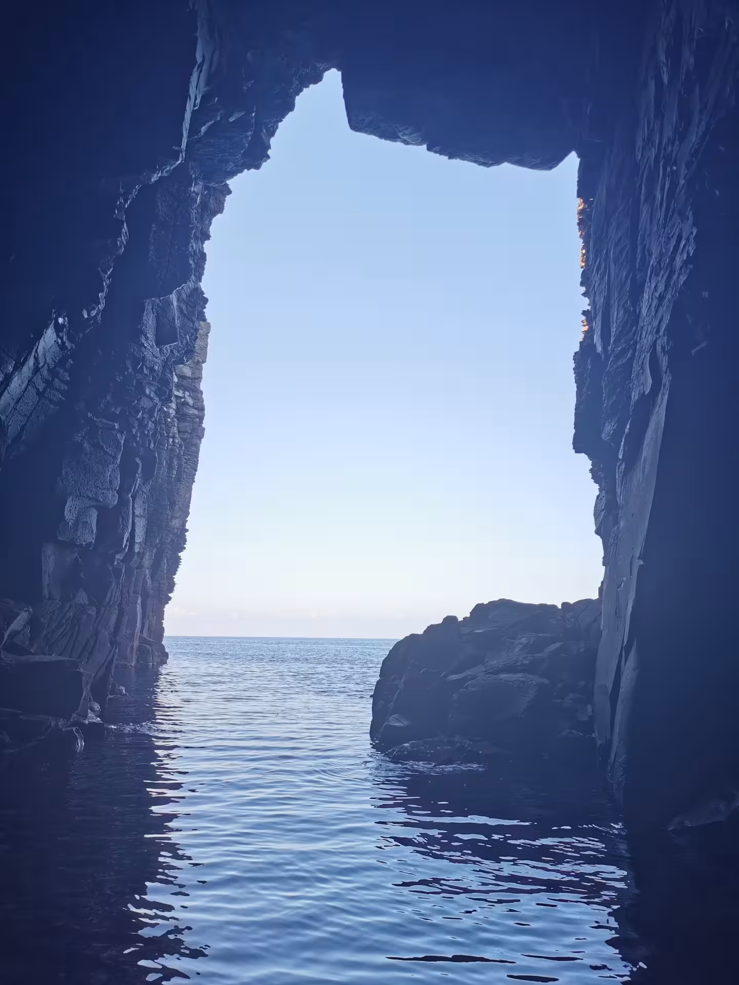 Discover a breathtaking sea cave entrance with serene waters on the Sant'Antioco to Carloforte RIB adventure.