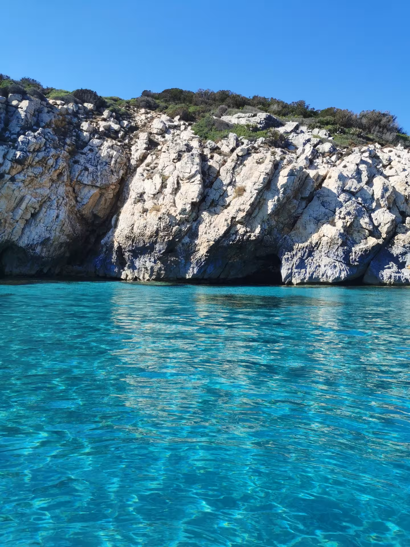 Discover the breathtaking cliffs and azure waters on the Sant'Antioco to Carloforte RIB tour adventure.