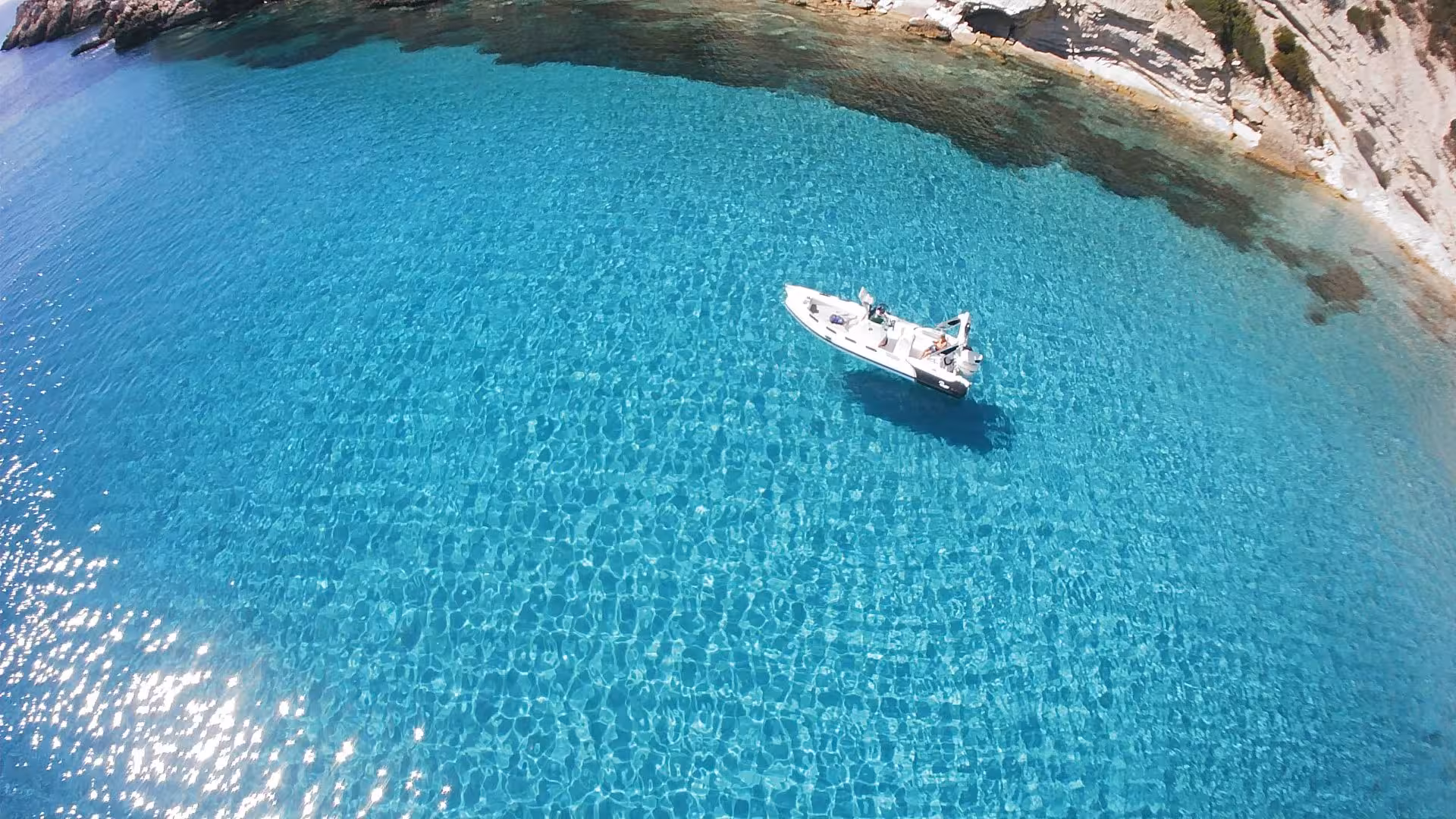 Aerial view of a RIB boat floating in the turquoise waters of Sant'Antioco, perfect for a 4-hour scenic tour.