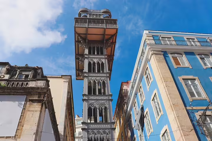 The iconic Santa Justa Lift in Lisbon, framed by colorful buildings, highlights the historic charm of a private walking tour.