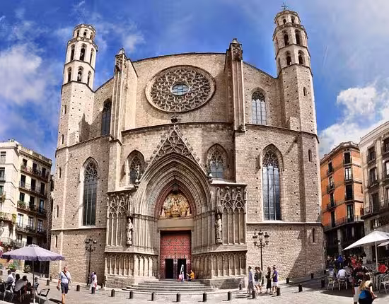 Majestic gothic architecture of Santa Maria del Mar church in Barcelona's Ribera district under a blue sky.