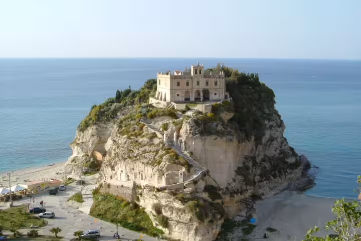 Sanctuary of Santa Maria dell’Isola perched on a rocky promontory above Tropea beach and the clear Tyrrhenian Sea in Calabria