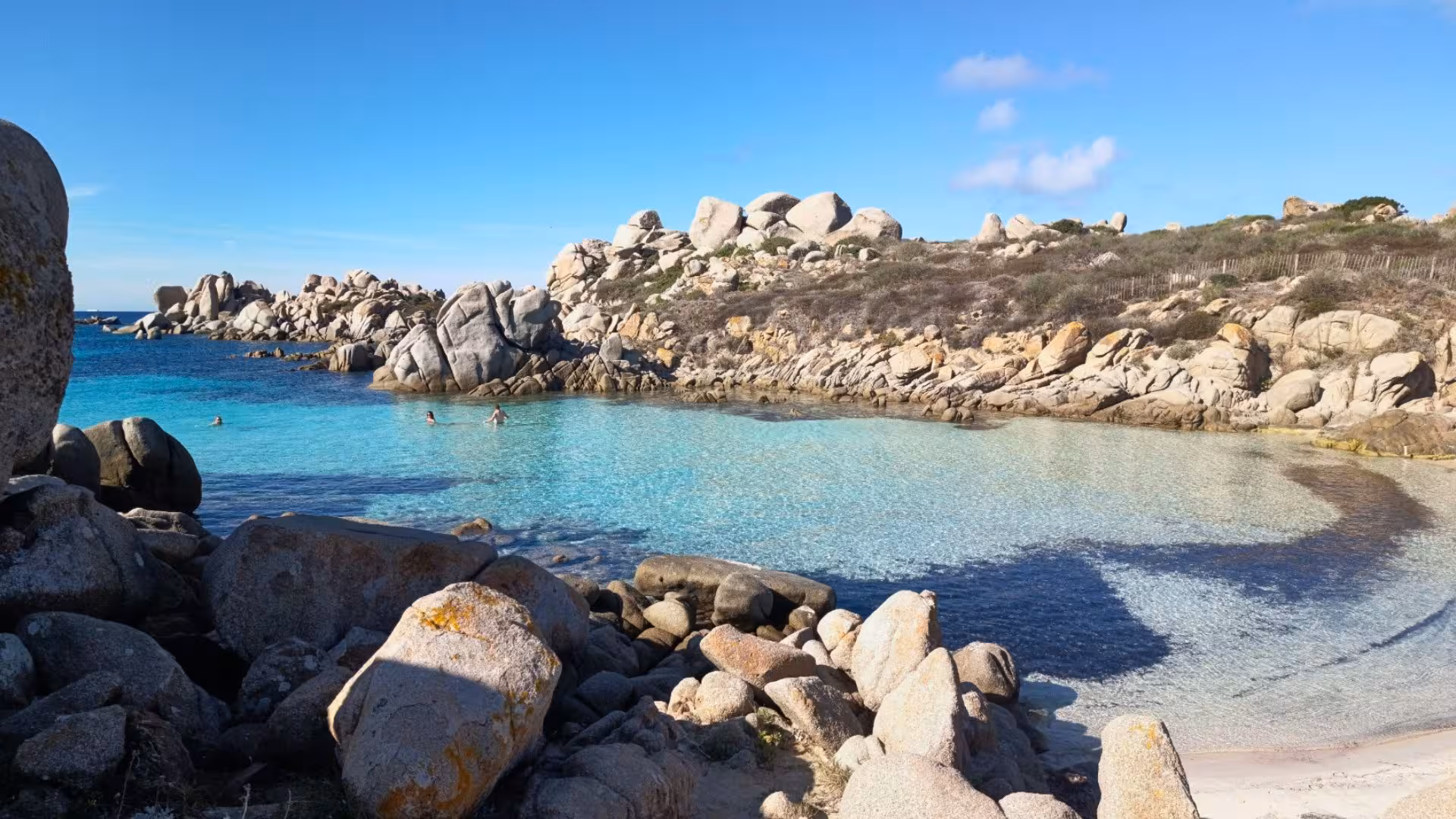 Pristine turquoise waters and rocky coastline in southern Corsica, ideal for a sailing tour from Santa Teresa di Gallura.