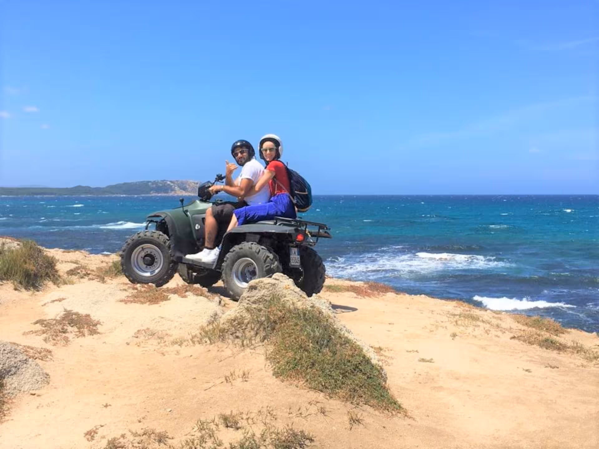 Couple enjoying an exhilarating ATV ride along the scenic coastline of Santa Teresa di Gallura.