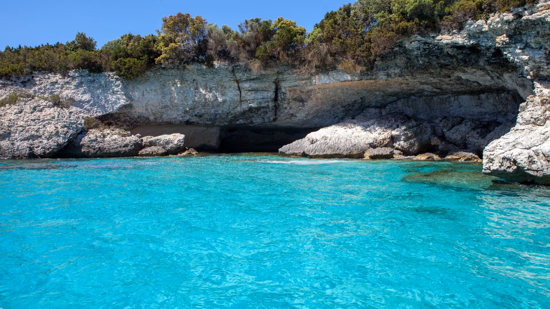 Crystal-clear waters and rocky coastline of southern Corsica, perfect for exploration on a dinghy tour from Santa Teresa di Gallura.