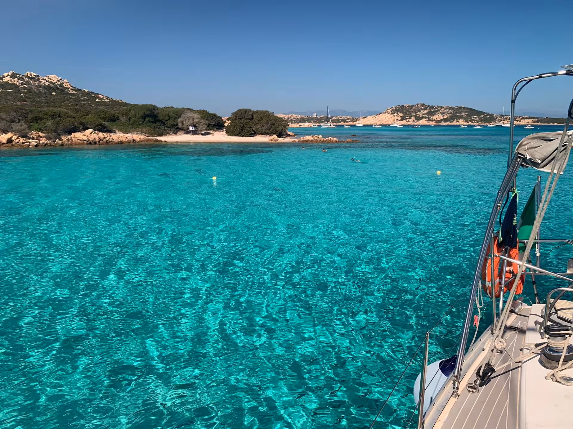 Crystal clear turquoise waters off the coast, perfect for Santa Teresa di Gallura to Corsica sailing adventure.