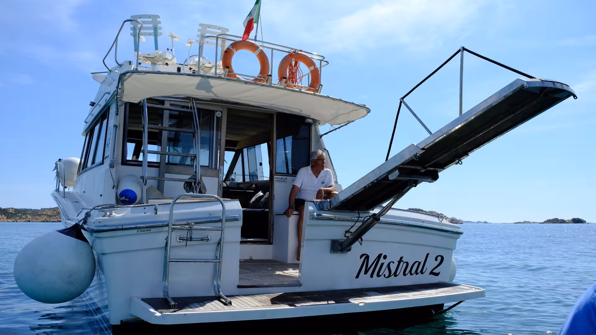 Relax on the deck of the Mistral 2 during a scenic speedboat tour from Santa Teresa di Gallura to Corsica's coast.