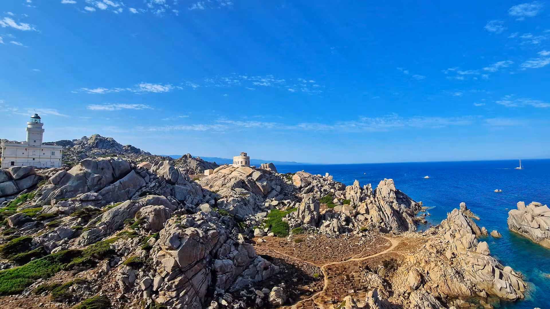 Scenic view of Santa Teresa Gallura's Valle della Luna, highlighting rocky landscape and azure Mediterranean Sea.