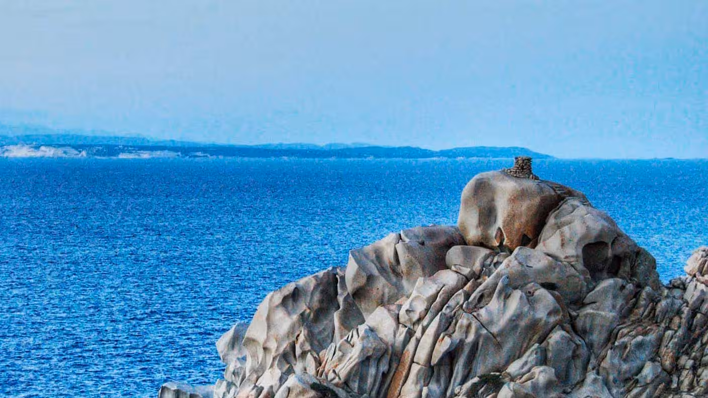 Majestic rock formations overlooking the azure sea in Santa Teresa Gallura's Valle della Luna hiking trail.