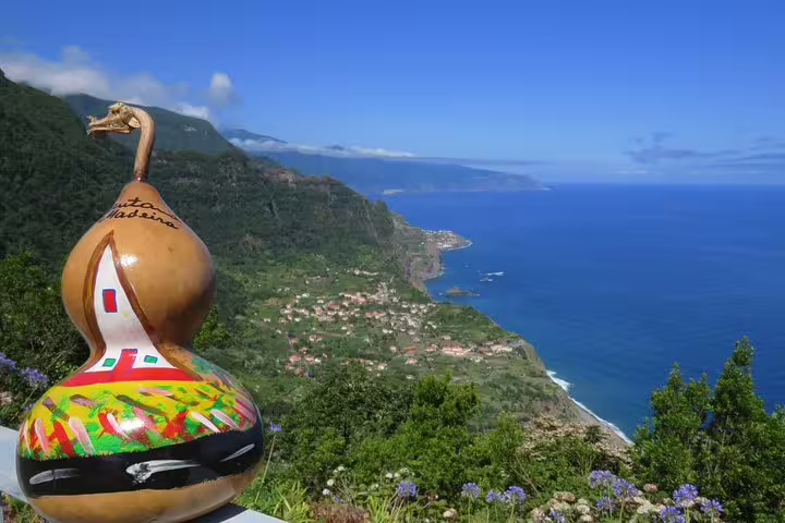 Stunning coastal view of Madeira's lush landscape and vibrant art during the Full Day Santana Wonders and Northeast 4WD Experience.