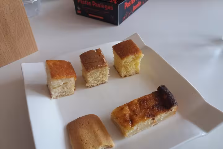 Delicious assortment of traditional pastries showcased on a plate during the full-day gastronomy tour in Santander.
