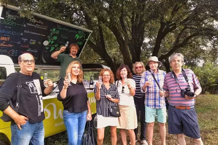 Group enjoying a wine tasting experience at a scenic stop on the full-day gastronomy tour from Santander.