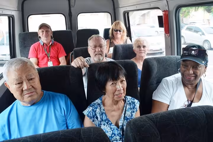 Tour group riding a minibus during Santarém do Pará city tour, Brazil, with guides and travelers onboard