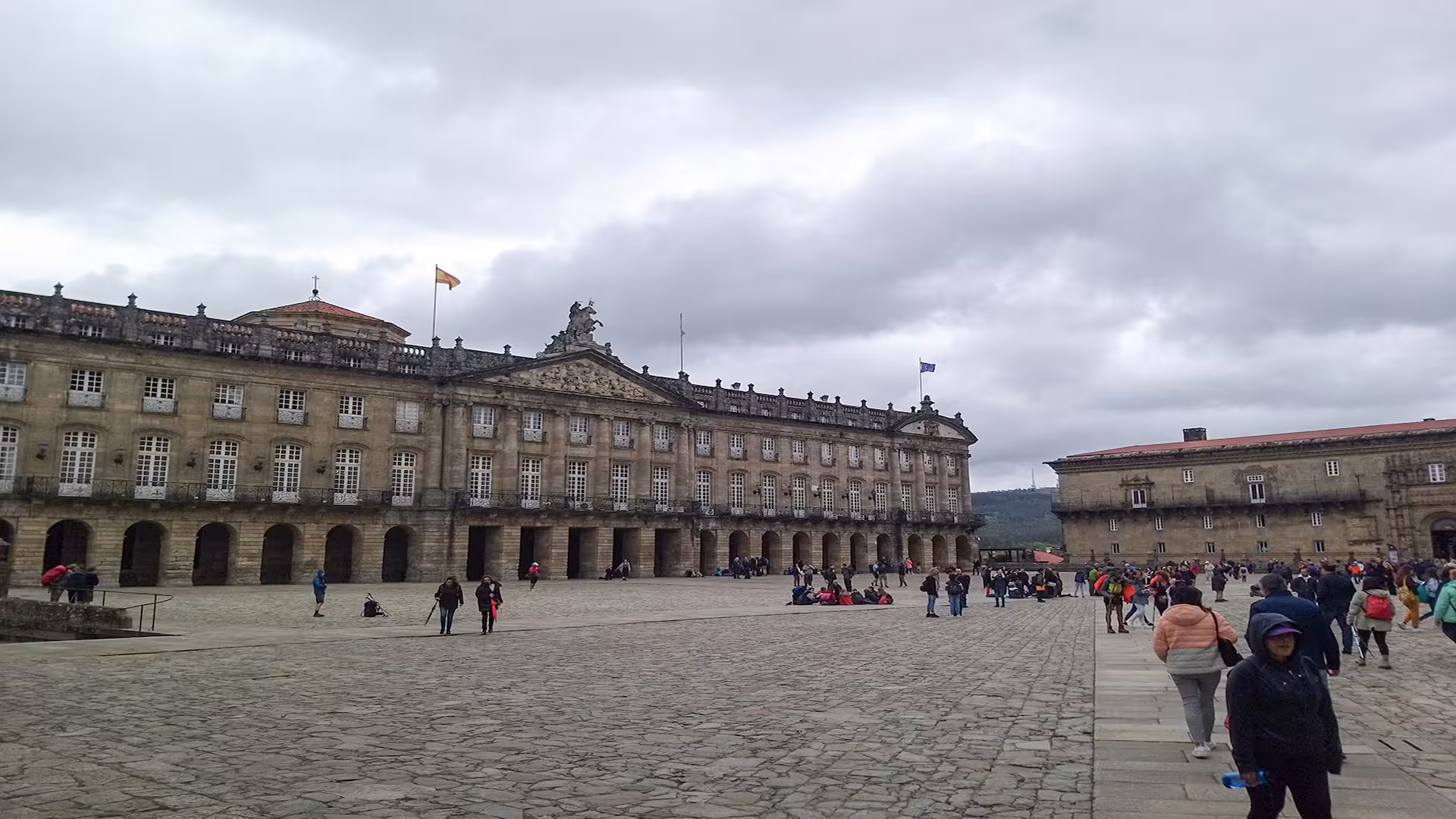 Vibrant plaza in Santiago de Compostela bustling with tourists, framed by historic architecture for a private cathedral tour.
