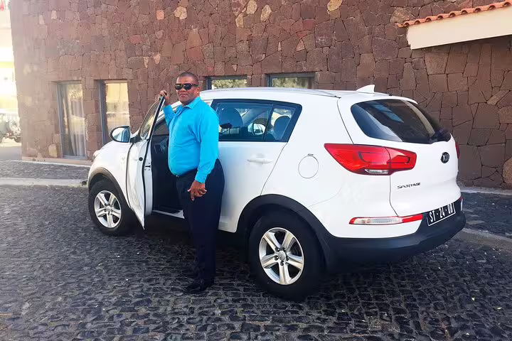 Driver beside white SUV for Santiago Island private airport transfer to Tarrafal, Cape Verde, hotel pickup