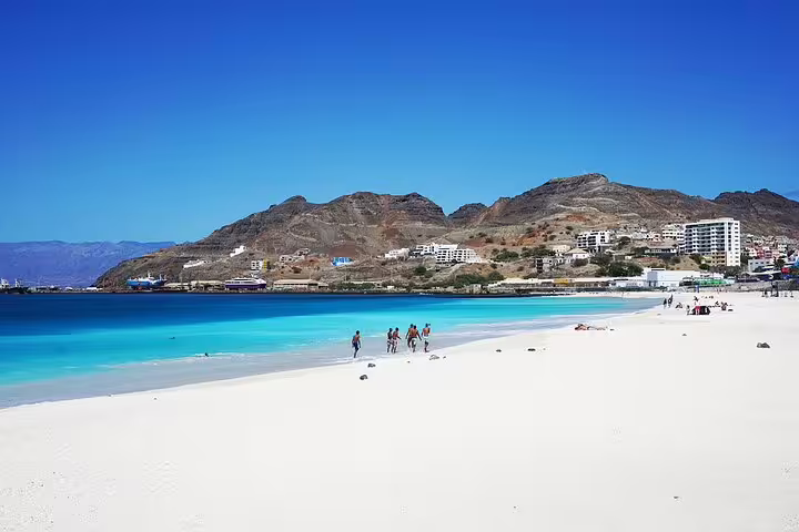 Pristine beach with turquoise waters and distant hills on Santiago Island, perfect stop for Assomada to Tarrafal transfer.