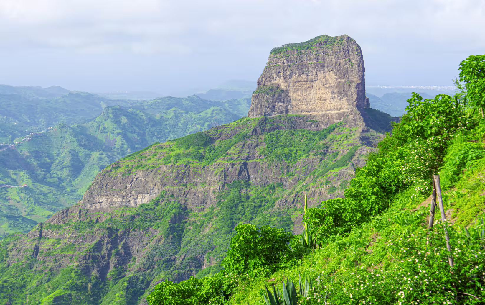 Lush green mountains of Santiago Island offer stunning views on the Banana Plantation Tour.