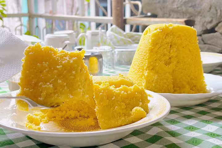 Traditional Cape Verdean cornmeal dish served on a checkered table during Santiago Island tour.