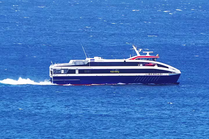 Fast ferry cruising the vibrant blue waters near Santiago Island, offering seamless private port transfer to Praia hotels.