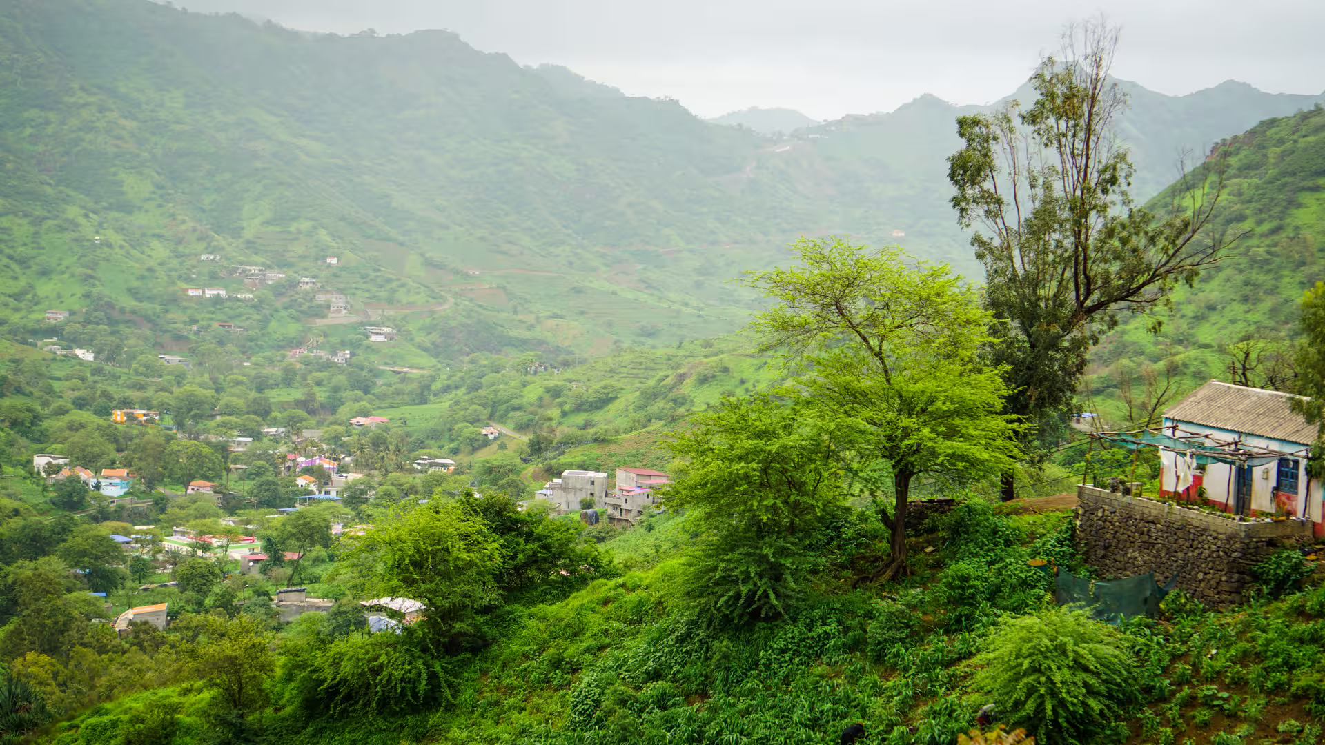 Scenic view of Longueira village nestled in verdant valleys on Santiago Island, perfect for a hiking adventure.