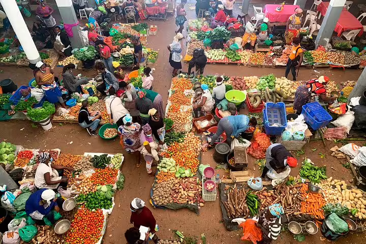 Vibrant market scene on Santiago Island, Cape Verde, showcasing diverse fresh produce and bustling local vendors.