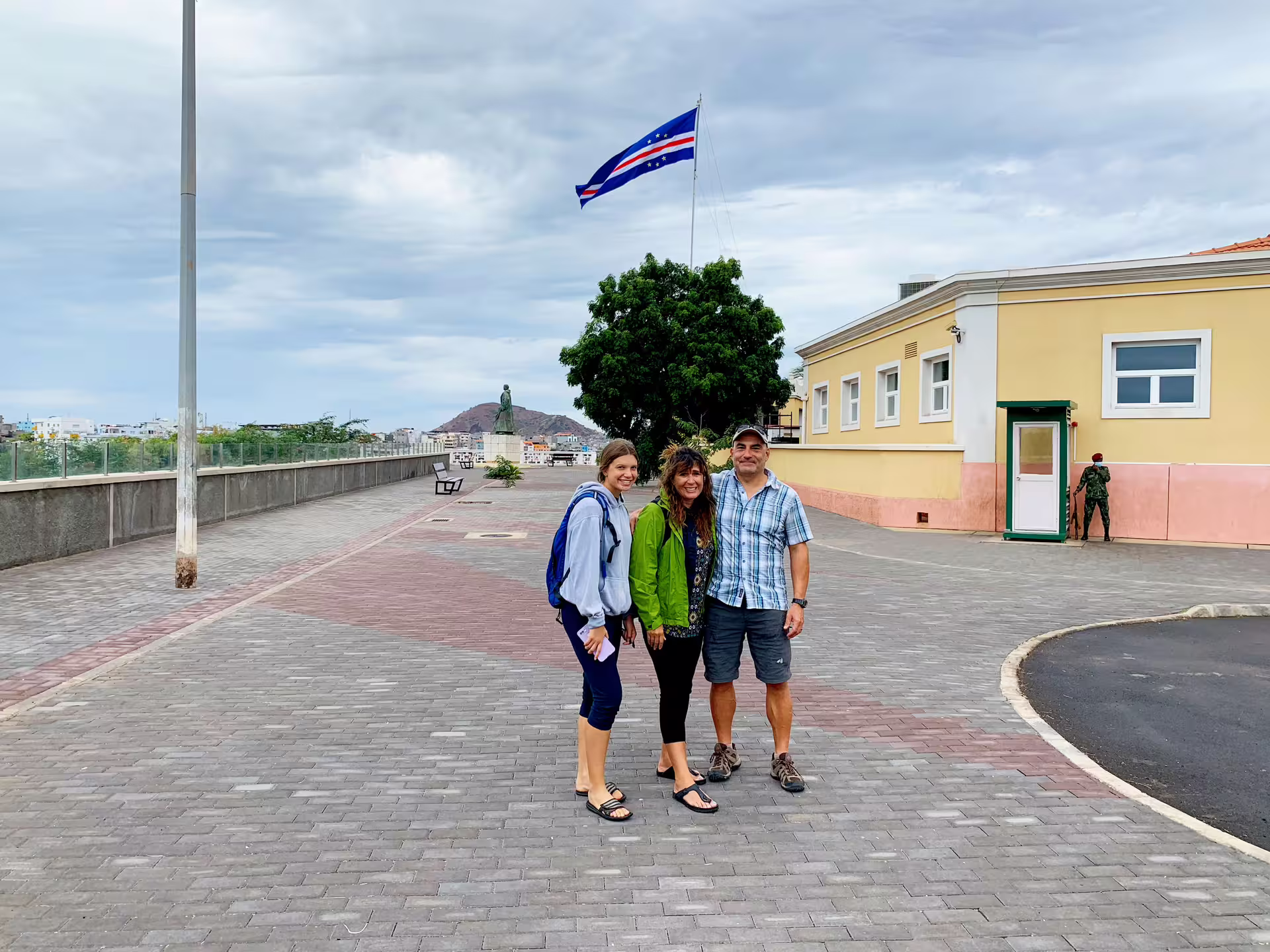 Tour guests at a Praia viewpoint overlooking Santiago Island bay, colorful boats and Cidade Velha coast