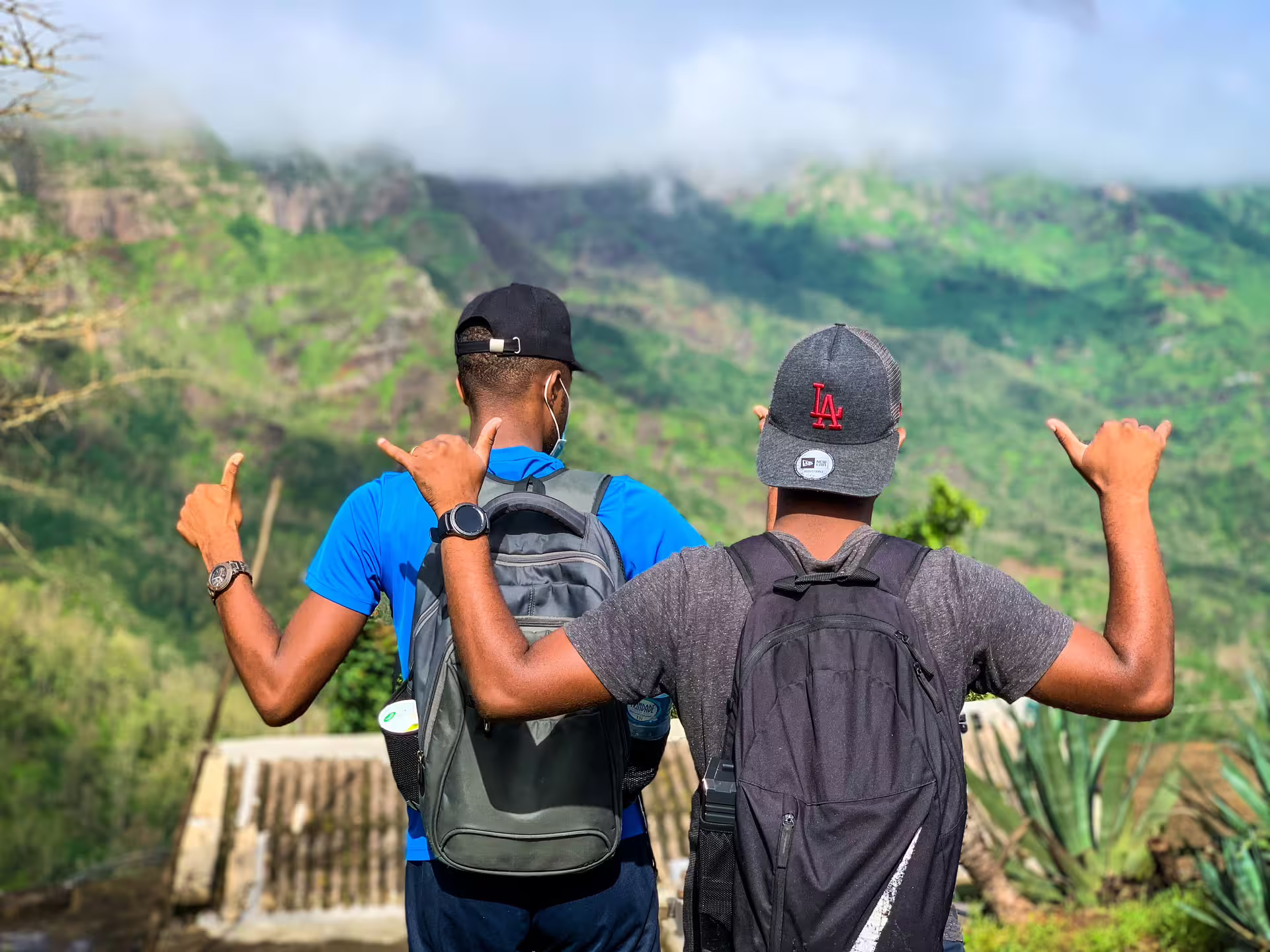 Two hikers with backpacks enjoy the scenic view from Rui Vaz on Santiago Island during a Longueira hike tour.