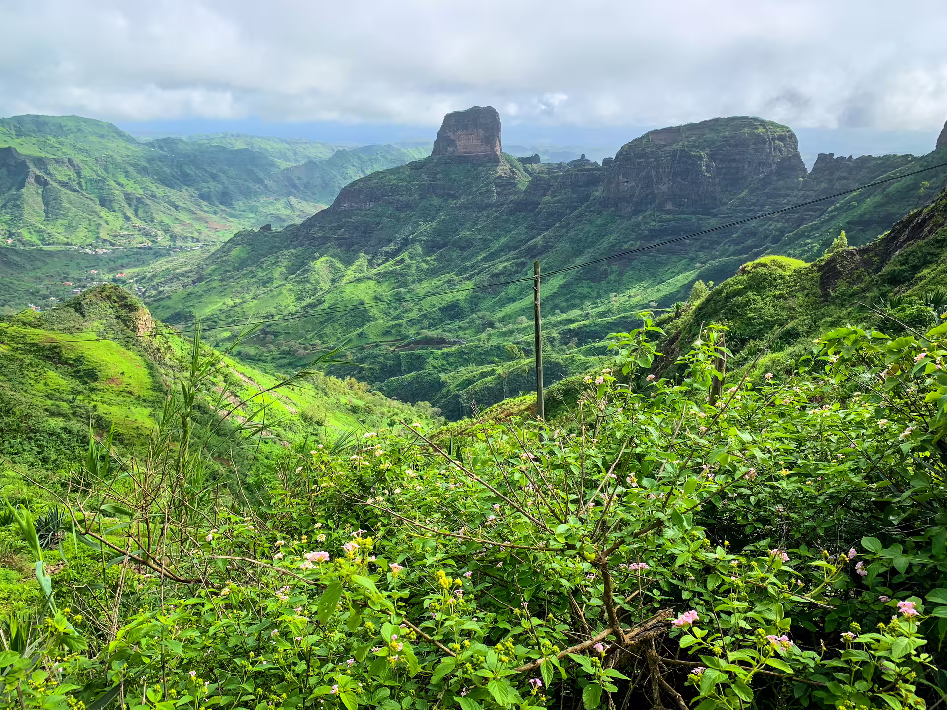Scenic view of lush green mountains and valleys on Santiago Island's Rui Vaz Longueira hiking trail.