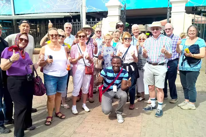 Cruise guests pose with local guide in Praia on a 7-hour guided Santiago Island shore excursion tour
