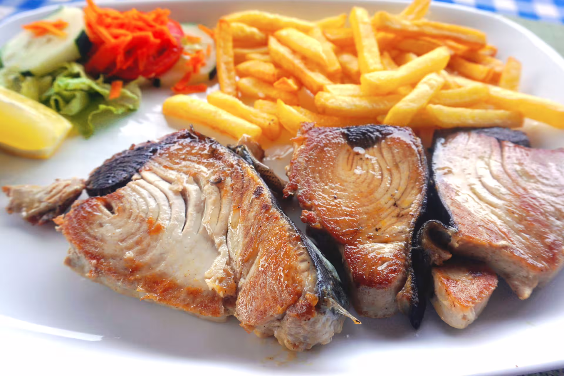 Grilled tuna with fries and salad, authentic Cape Verde lunch during Santiago Island tour from Praia to Tarrafal