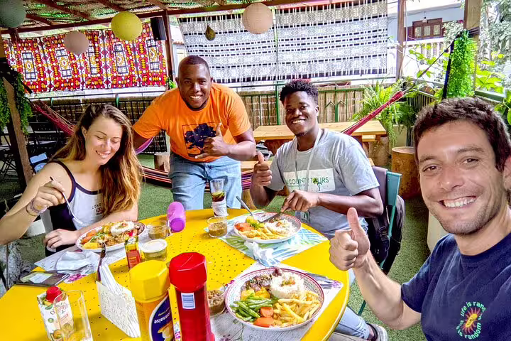 Group enjoying a meal with a local family during a Santiago Island tour, creating memorable connections.