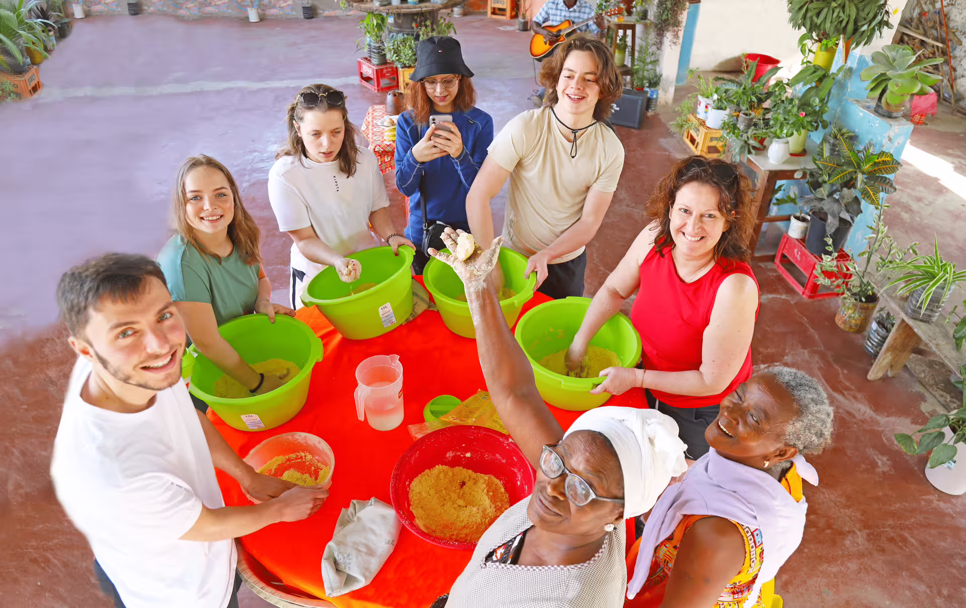 Santiago Island workshop experience with local hosts, tourists mixing traditional ingredients during cultural tour