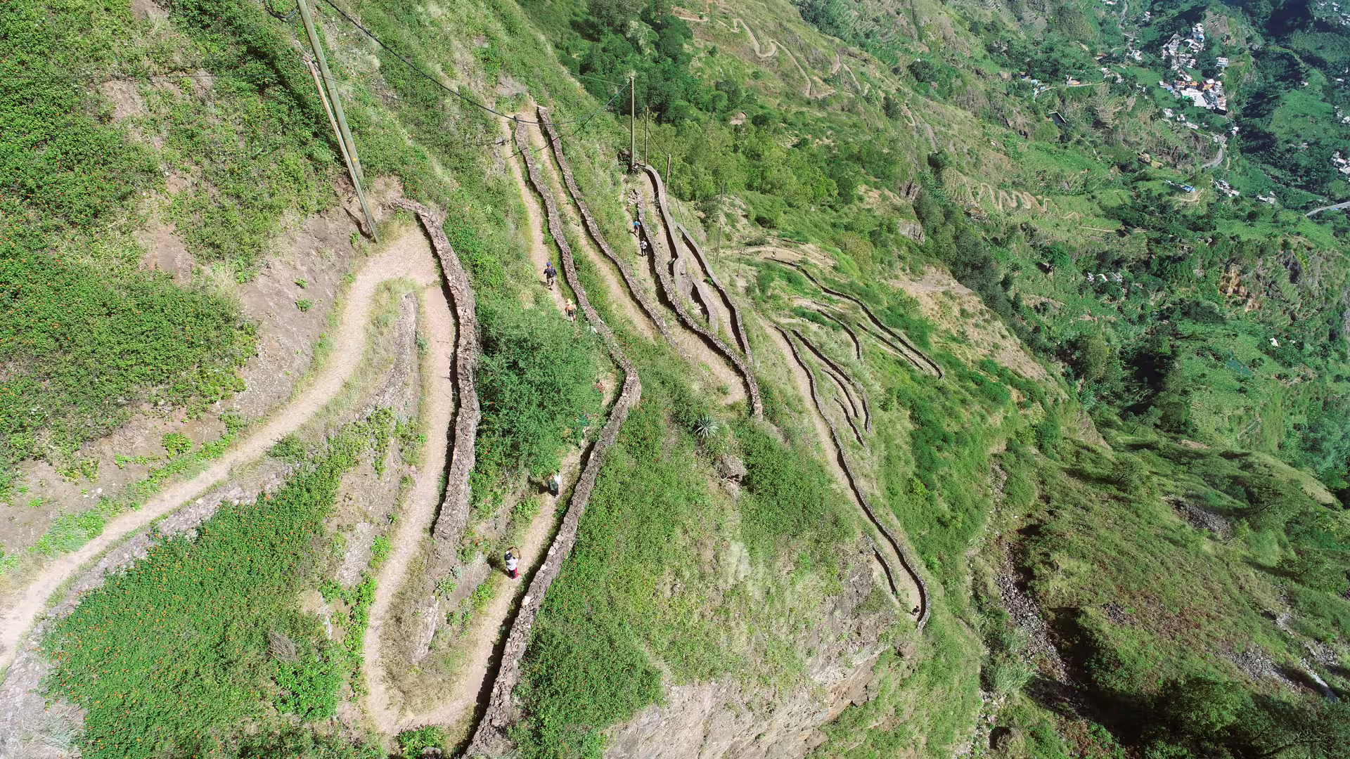 Aerial view of winding stone paths in lush green Cova de Paúl, perfect for trekking enthusiasts on Santo Antão.