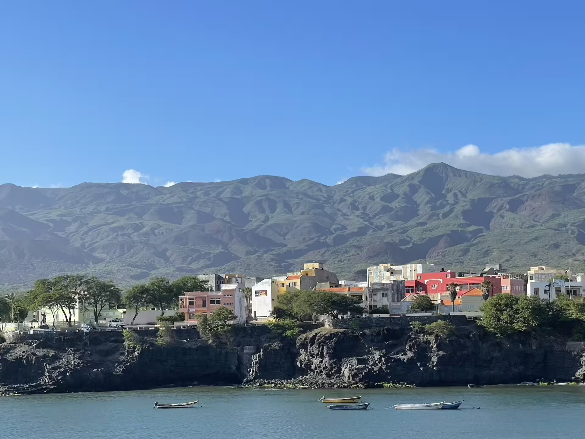 Colorful coastal village and lush mountains in Santo Antão, Cape Verde, ideal for exploring the scenic Valley of Paul on a trek.