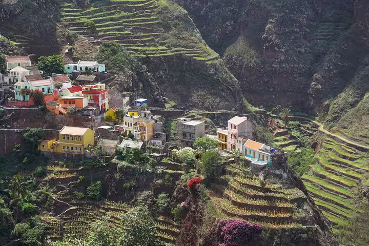 Colorful hillside village nestled among terraced fields in Santo Antão, showcasing vibrant Cape Verde culture.