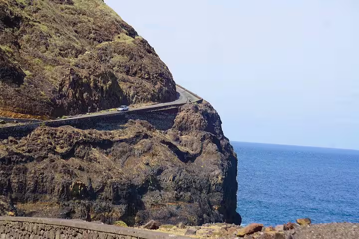 Scenic road winding along steep cliffs overlooking the ocean near Cruzinha on Santo Antão island.